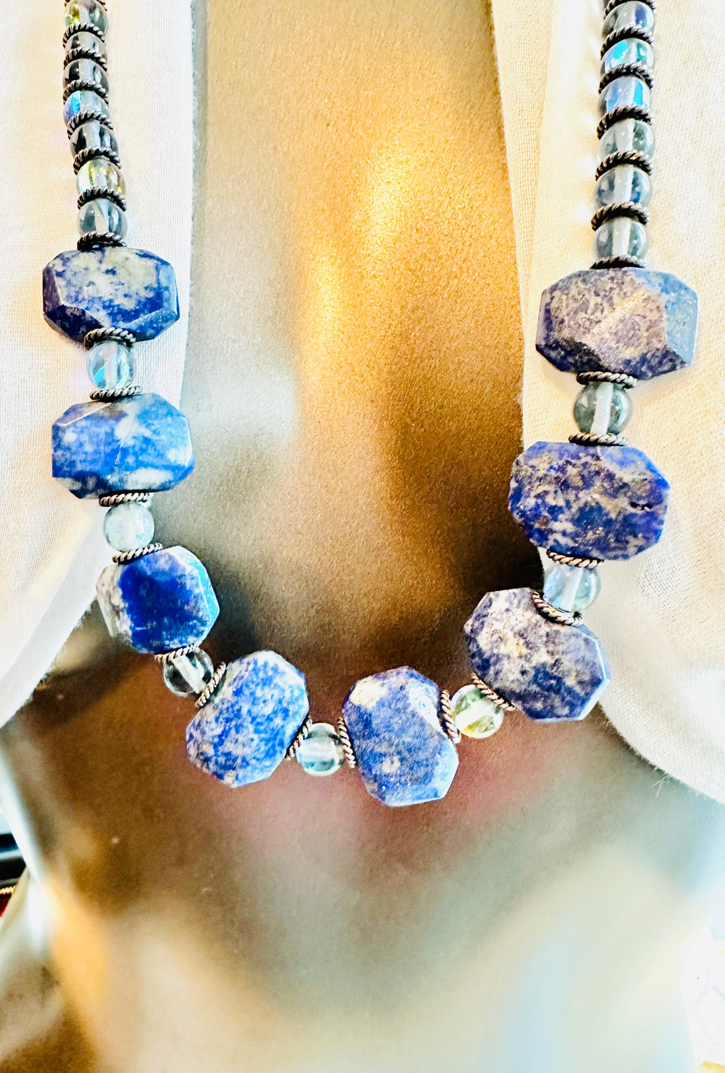 The pieces are crafted with care and feature a combination of gemstones, sterling silver, sodalite, and opalite.
The adjustable necklace measures between 14 to 24 in