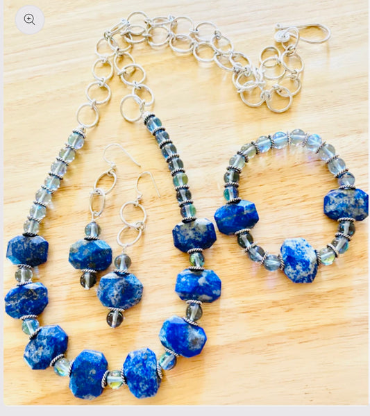 The pieces are crafted with care and feature a combination of gemstones, sterling silver, sodalite, and opalite.
The adjustable necklace measures between 14 to 24 in