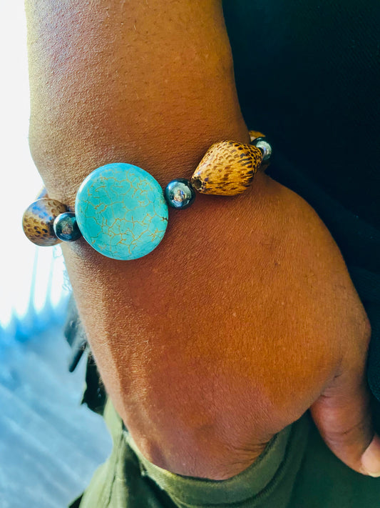 Wood, hematite; turquoiseHandmade JewelryFree U.S Shipping on orders over $25 This bracelet is the perfect way to dress up any look. Wear it for a night out, a day
