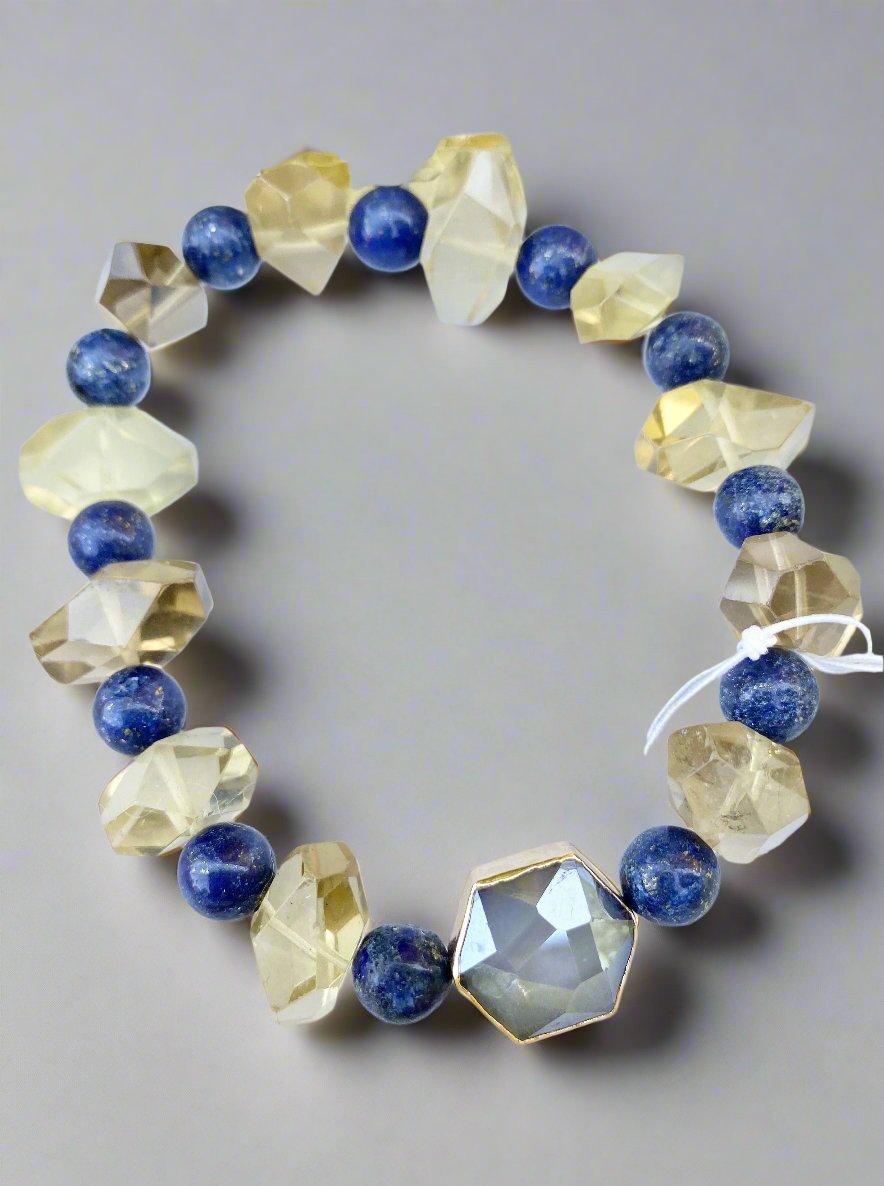 A unique piece comprised of lapis luzi and lemon quartz, this stretch bracelet is an exquisite combination of blue, yellow, and silver. A handcrafted work of art,