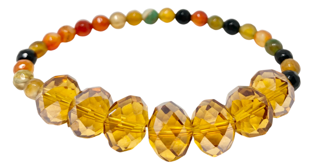  
Agate is known to bring serenity, safeguard against life's obstacles, and sharpen focus. This stretch bracelet is made with a variety of hues, including brown, bla